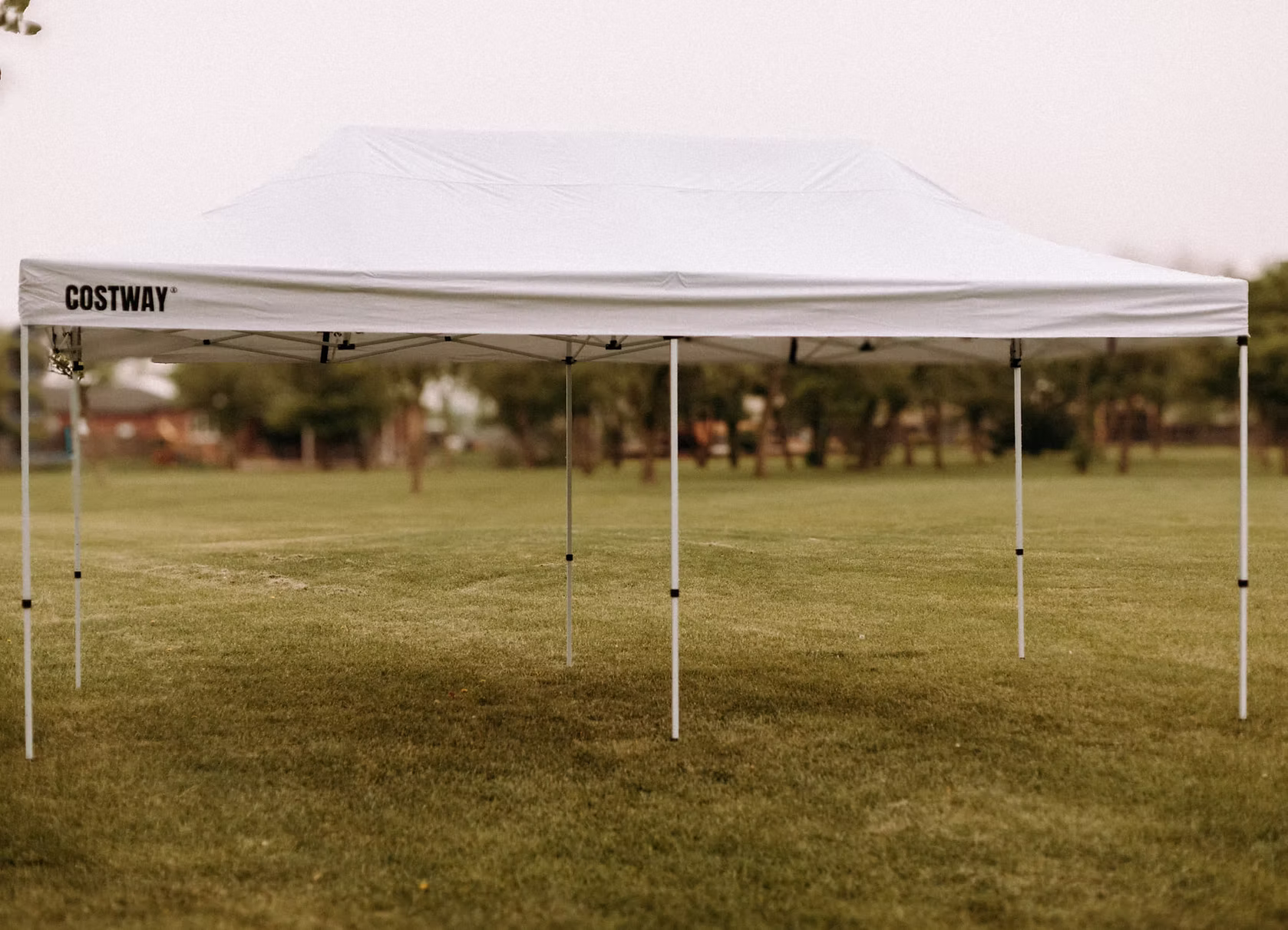 10 by 20 foot white party tent on grass.